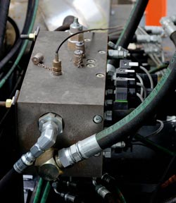 A custom hydraulic manifold from Sun Hydraulics controls the fan drive motor, circulation motor, water pump motor, blower motor and fuel pump motor.